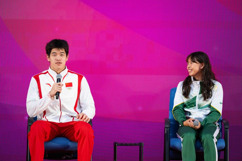 9月1日，游泳運動員潘展樂（左）在活動中回答澳門運動員的提問。當日，內(nèi)地奧運健兒代表團在澳門奧林匹克體育中心室內(nèi)體育館與澳門青少年運動員進行互動交流。新華社記者 張金加 攝