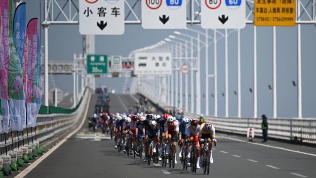 參加第十五屆全國運動會公路自行車男子個人賽的選手在港珠澳大橋上騎行